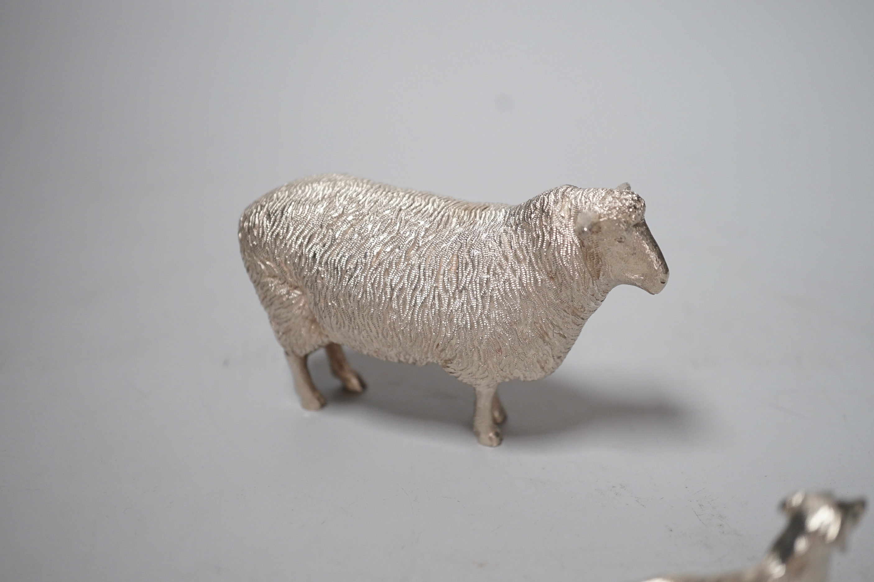 An Elizabeth II silver free-standing model of a sheep, Edward Barnard & Sons Ltd, London, 1993, length 95mm and a smaller silver model free-standing dog, 8.6oz.
